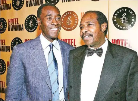  ?? GETTY IMAGES/AFP ?? Paul Rusesabagi­na (right) is pictured with US actor Don Cheadle who played him in the Hollywood film
Hotel Rwanda.