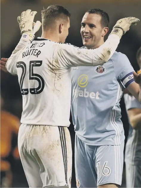  ??  ?? Sunderland keeper Robbin Ruiter and defender John O’Shea celebrate a hard-earned point against Wolves earlier this month. Pic by Frank Reid.