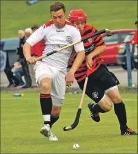  ?? Photo: Kevin McGlynn ?? Former Inverness Caley Thistle and Ross County goalkeeper Michael Fraser, now playing shinty for Glenurquha­rt, takes on Oban Camanachd’s Garry Lord.