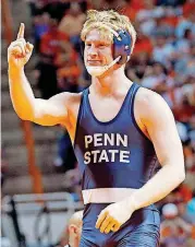  ??  ?? LEFT: Penn State’s Bo Nickal celebrates a pin over Oklahoma State’s Nolan Boyd in the 197-pound match Sunday in the NWCA Dual Championsh­ips at Gallagher-Iba Arena. Penn State improved to 14-0 with a 27-13 rout over the topranked Cowboys.