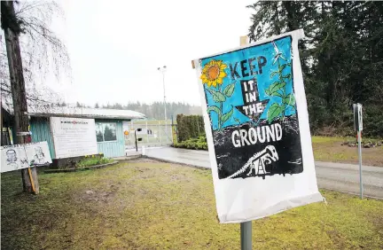  ?? BEN NELMS/BLOOMBERG ?? A protest sign stands outside the Kinder Morgan facility in Burnaby, B.C., last month. BCI, the pension fund manager for B.C.’s public sector staff, has increased its stake in Houston-based Kinder Morgan. Kinder Morgan’s Canadian unit is behind the...