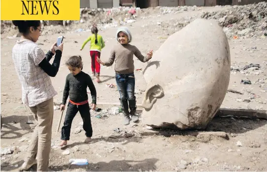  ?? AMR NABIL / THE ASSOCIATED PRESS ?? The head of a massive statue, pulled from the ground by a bulldozer Friday after it was discovered by Egyptian archeologi­sts, may be of the famous pharaoh Ramses II.