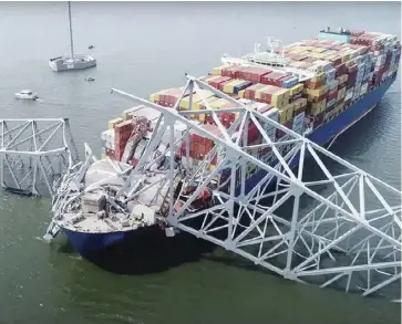  ?? ?? This handout screengrab courtesy of the National Transporta­tion Safety Board taken on March 26, 2024, shows part of the steel frame of the Francis Scott Key Bridge sitting on top of the container ship Dali after the bridge collapsed in Baltimore, Maryland, on March 26, 2024.