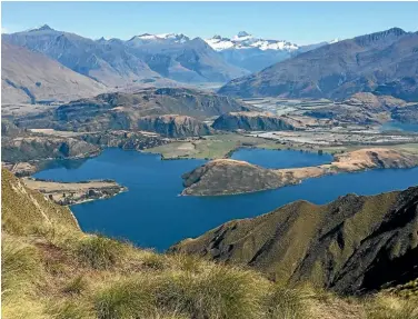  ?? Photo: MARJORIE COOK/FAIRFAX NZ ?? Mt Aspiring, centre, towers above New Zealand’s own beautiful Lake Wanaka.