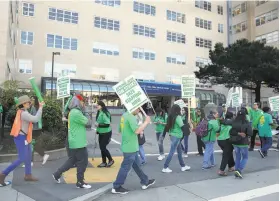  ?? Liz Hafalia / The Chronicle ?? Pickets chant at UCSF Medical Center, among thousands of UC vocational nurses, truck drivers, security guards and other service workers striking.