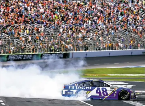  ?? Sean Gardner/Getty Images ?? Jimmie Johnson celebrates his win Sunday at the O’Reilly Auto Parts 500 at Texas Motor Speedway with a burnout.