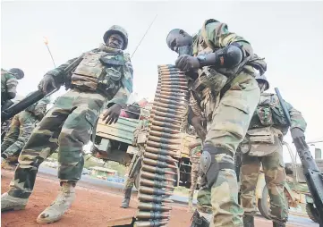  ??  ?? Members of the regional ECOWAS force are seen at the Denton Bridge check point in Banjul, Gambia. — Reuters photo