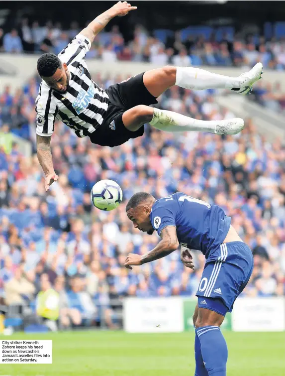  ??  ?? City striker Kenneth Zohore keeps his head down as Newcastle’s Jamaal Lascelles flies into action on Saturday.