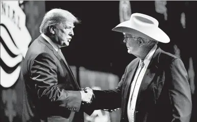  ?? MANDEL NGAN/GETTY-AFP 2019 ?? President Trump shakes hands with Arizona farmer Jim Chilton during the American Farm Bureau’s annual convention in New Orleans.