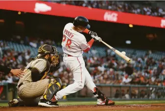  ?? Lachlan Cunningham / Getty Images ?? Giants catcher Buster Posey hits a solo home run in the bottom of the first inning against the San Diego Padres at Oracle Park. It was his 18th home run of the season.