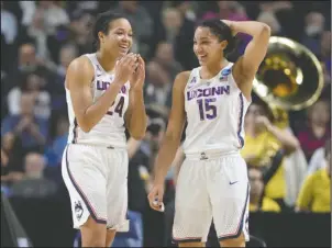  ?? The Associated Press ?? DYNAMIC DUO: Connecticu­t’s Napheesa Collier, left, and Gabby Williams share a light moment during the second half of a regional final game against Oregon in the NCAA women’s basketball tournament Monday in Bridgeport, Conn. The two combined for 53 of...
