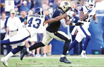  ?? SEAN M HAFFEY/GETTY IMAGES/AFP ?? John Johnson (left) of the Los Angeles Rams tackles Alvin Kamara of the New Orleans Saints during the NFL game at the Los Angeles Memorial Coliseum on Sunday.