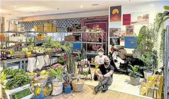  ??  ?? Chef JP Anglo (seated) with wife Camille beside their small vegetable stand and potted plants.