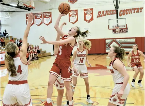  ?? Photo by John Zwez ?? Nikane Ambos of Wapakoenta goes up for a shot in between three New Knoxville defenders during last Saturday’s game. the Lady Redskins travel to Kenton this evfening.