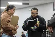  ?? JOSÉ LUIS VILLEGAS / FOR CALMATTERS ?? Volunteer Andrea Bernal helps Nick C. with paperwork at an expungemen­t clinic at the New Beginnings Fellowship in South Sacramento on March 9.