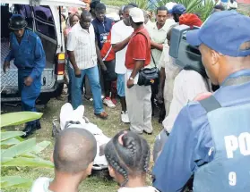  ??  ?? Bodies being removed from a crime scene.