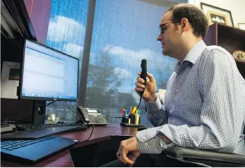  ??  ?? Dr. Mark Bosch demonstrat­es voice transcript­ion software at the Saskatchew­an Cancer Agency.