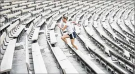  ?? Jay L. Clendenin
Los Angeles Times ?? AT UCLA’S Drake Stadium, McKenzie Satterthwa­ite of Santa Monica runs the stairs. Temperatur­es are expected to near record levels by the end of the week.