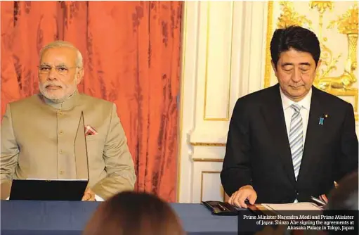  ??  ?? Prime Minister Narendra Modi and Prime Minister of Japan Shinzo Abe signing the agreements at
Akasaka Palace in Tokyo, Japan