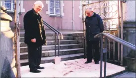  ?? ?? ABOVE - Holy War - Fermoy parish priest, Anthony O’Brien and Michael O’Connell testing the disinfecta­nt mat outside St Patrick’s church in Fermoy, to help contain the spread of foot and mouth.