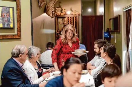  ?? Photos by Justin Katigbak/Special to The Chronicle ?? Cheryl Maloney, the new owner of La Ciccia and a longtime patron, gathers plates from customers at the S.F. restaurant.