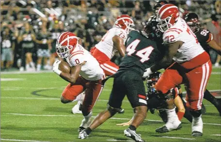  ?? Jason Armond Los Angeles Times ?? MATER DEI running back Jordon Davison picks up some yards on the ground during the first half against Corona Centennial.