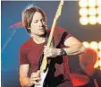  ?? RICK DIAMOND/GETTY IMAGES FOR CMT ?? Country musician Keith Urban will bring his “RipCORD” world tour to Perfect Vodka Amphitheat­re on June 18. Tickets will go on sale Friday.