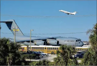  ?? RICHARD GRAULICH / THE PALM BEACH POST ?? An Air Force C-17 aircraft arrives Sunday at Palm Beach Internatio­nal Airport carrying equipment for President Donald Trump’s Thanksgivi­ng holiday visit to Mar-a-Lago.