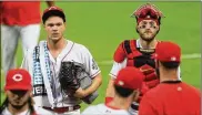  ??  ?? Reds pitcher Sonny Gray and catcher Tucker Barnhart return to the dugout after warming up Monday. Gray’s 0.94 ERA is the fourth-best mark in the National League, after three starts. Reds starters have a 2.63 ERA, the third-best mark in the league.