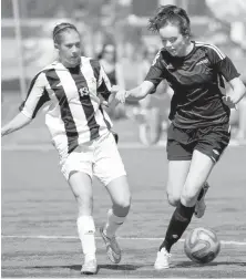  ?? DARREN STONE, TIMES COLONIST ?? Englin Park’s Sally Matthews, right, fights off a tackle from Kathryn Harvey of Charles Best during semifinal action Friday at the B.C. triple-A championsh­ip at UVic.