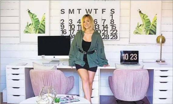  ?? Photograph­s by Jesse Goddard For The Times ?? A MASSIVE calendar is a centerpiec­e of YouTube influencer Alisha Marie’s home office. And, of course, the pink chairs.