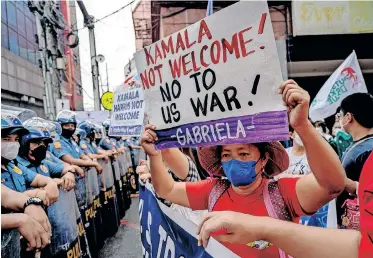  ?? | Reuters ?? A PROTESTER holds a placard during a protest against US Vice-President Kamala Harris’ visit to the Philippine­s, in Manila, yesterday.