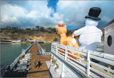  ?? Mel Melcon Los Angeles Times ?? A COLD weather alert has been issued by the L.A. County Department of Public Health, warning of wind chill temperatur­es below 32 degrees in some areas Wednesday. Above, the season is in full swing on the Malibu Pier.