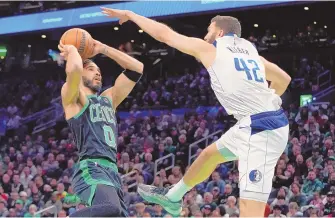  ?? ASSOCIATED PRESS ?? The Boston Celtics’ Jayson Tatum (0) looks to shoot against the Dallas Mavericks’ Maxi Kleber (42) during the first half of Friday’s game in Boston.