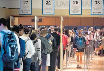  ?? Jeff Swensen Getty Images ?? PENN STATE students wait to vote Nov. 8, 2016. After President Trump lost the popular vote by nearly 3 million he formed a voter fraud panel, which is accused of withholdin­g documents from Democratic members.