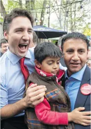  ?? PAUL CHIASSON / THE CANADIAN PRESS ?? Justin Trudeau poses with Arif Virani and his son during a campaign stop in 2015. Virani, a Liberal MP, recently travelled to London on the Trudeau Foundation’s dime.