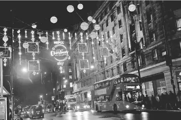  ?? — Reuters photo ?? A bus passes the Oxford Street Christmas lights, in London.