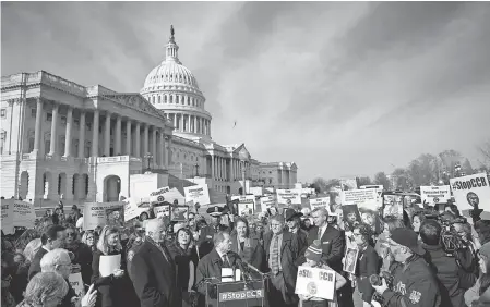  ??  ?? Demonstrat­ors gather on Capitol Hill to oppose concealed carrying of guns. The House on Wednesday passed legislatio­n that would require each state to recognize permits from other states. BRENDAN SMIALOWSKI/AFP/GETTY IMAGES