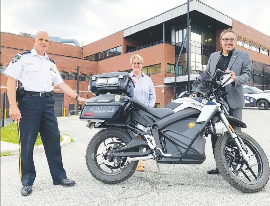 ?? MATTHEW MCCULLY ?? Danny Mcconnell, Director of the Sherbrooke Police Service with Danielle Berthold, Sherbrooke Councillor and President of the City’s Public Security Committee and Steve Lussier, Mayor of Sherbrooke having a look at the newly acquired electric motorcycle joining the Service Police Service fleet.