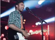  ??  ?? A singer-songwriter (Himesh Patel) claims the Beatles’ songs as his own in the new movie “Yesterday.”