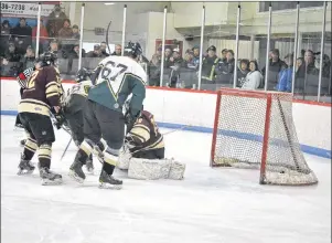  ?? ERIC MCCARTHY/JOURNAL PIONEER ?? Alberton Regals captain Logan Smallman, 16, manages to pick the puck out of Maroons goaltender Chase Dyment’s pads and score. His brother, Jason Smallman, 67, was in position if a rebound had been granted. The Regals won Game 3 of their best-of-five...