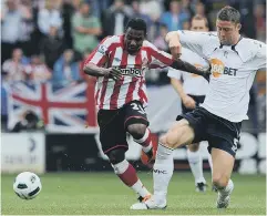  ??  ?? Stephane Sessegnon takes on Bolton’s Gary Cahill.