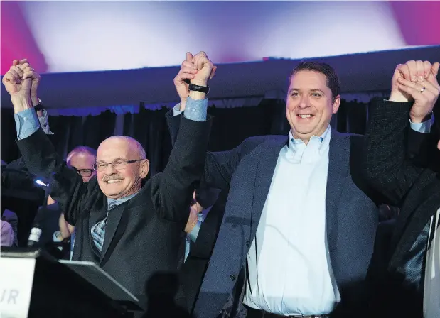  ?? JACQUES BOISSINOT / THE CANADIAN PRESS ?? Conservati­ve Leader Andrew Scheer, right, raises arms on Saturday with Richard Lehoux, left, the party’s choice to run in the riding of Beauce in the 2019 federal election. Lehoux was the mayor of Saint-Elzear, Que., and the former president of an associatio­n of Quebec municipali­ties.