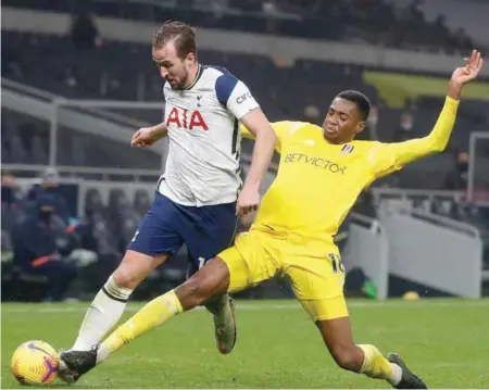  ??  ?? Tosin Adarabioyo tries to stop Harry Kane when Tottenham hosted Fulham in the Premier League