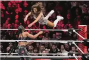  ?? Charles Krupa/Associated Press ?? Carmella leaps at Bianca Belair, during a WWE Monday Night RAW event in March 2023, in Boston. In January 2025, Raw will move from USA Network to Netflix, in a 10-year deal worth more than $5 billion.