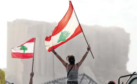  ?? PHOTO: REUTERS/GORAN TOMASEVIC ?? Distress signal: Protestors wave Lebanese flags near the site of a blast at Beirut’s port area, Lebanon.