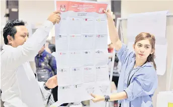  ?? – Bernama photo ?? Workers at the World Trade Centre in Kuala Lumpur carrying out the vote-counting process for Indonesia’s general elections.