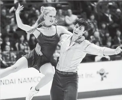  ?? ANTONIO CALANNI THE ASSOCIATED PRESS ?? Waterloo’s Katelyn Weaver and Andrew Poje perform Saturday during pairs ice dance at the World Figure Skating Championsh­ips in Assago, near Milan. This is their third world championsh­ip medal. Olympic gold medallists Tessa Virtue and Scott Moir did not...