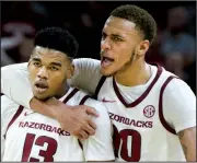  ??  ?? LEFT Arkansas forward Daniel Gafford (right) embraces guard Mason Jones during Sunday’s game against Indiana at Bud Walton Arena in Fayettevil­le. Gafford finished with a career-high a career-high 27 points, 12 rebounds, 3 blocked shots and 2 steals, and Jones hit the winning free throw with 2 seconds left to lead the Razorbacks to a 73-72 victory. RIGHT Arkansas guard Jalen Harris (5) drives for a layup over Indiana guard Romeo Langford. Harris had five points and four assists.
