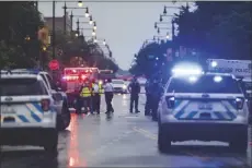  ?? ASSOCIATED PRESS ?? CHICAGO POLICE INVESTIGAT­E the scene of a mass shooting where more than a dozen people were shot in the Gresham neighborho­od of Chicago, Tuesday.